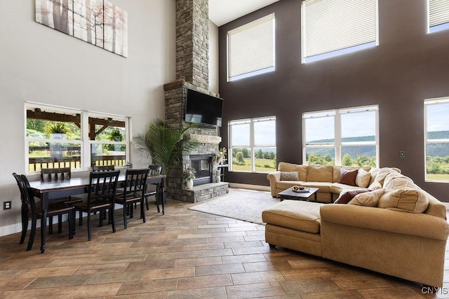 3785 Ransom Rd, Pompey, NY 13078 - living room with a towering ceiling, a fireplace, plenty of natural light, and wood finished floors