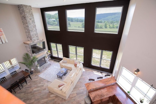 3785 Ransom Rd, Pompey, NY 13078 - living area featuring a towering ceiling, healthy amount of natural light, a fireplace, and ornate columns