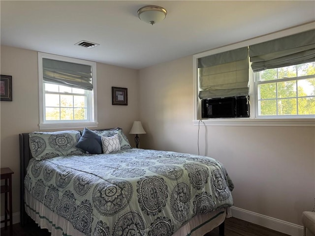 6303 Palmiter Rd, Alfred, NY 14803 - bedroom with multiple windows, cooling unit, and wood finished floors