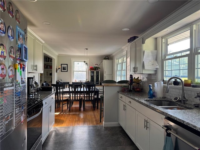 6303 Palmiter Rd, Alfred, NY 14803 - kitchen with appliances with stainless steel finishes, decorative backsplash, white cabinets, recessed lighting, and decorative light fixtures