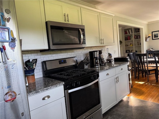 6303 Palmiter Rd, Alfred, NY 14803 - kitchen with stainless steel appliances, crown molding, backsplash, dark stone counters, and white cabinets