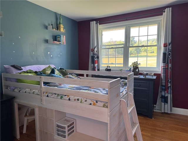 6303 Palmiter Rd, Alfred, NY 14803 - bedroom featuring multiple windows and wood finished floors