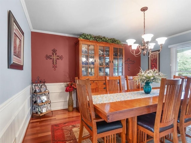 27 Black Spruce Ct, Greece, NY 14616 - dining room with a chandelier, crown molding, wood finished floors, and wainscoting