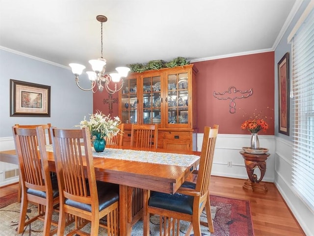 27 Black Spruce Ct, Greece, NY 14616 - dining room with a chandelier, light wood finished floors, ornamental molding, and wainscoting