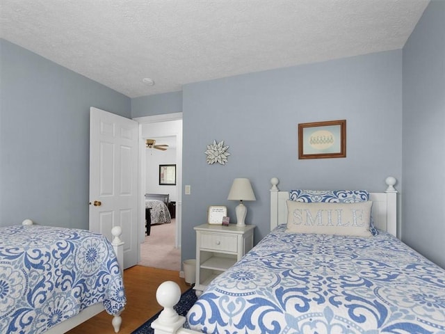 27 Black Spruce Ct, Greece, NY 14616 - bedroom featuring wood finished floors and a textured ceiling