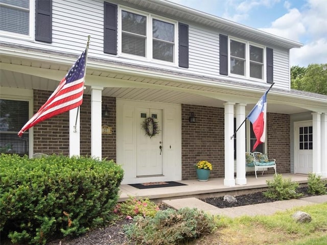 27 Black Spruce Ct, Greece, NY 14616 - view of front of house featuring brick siding and covered porch