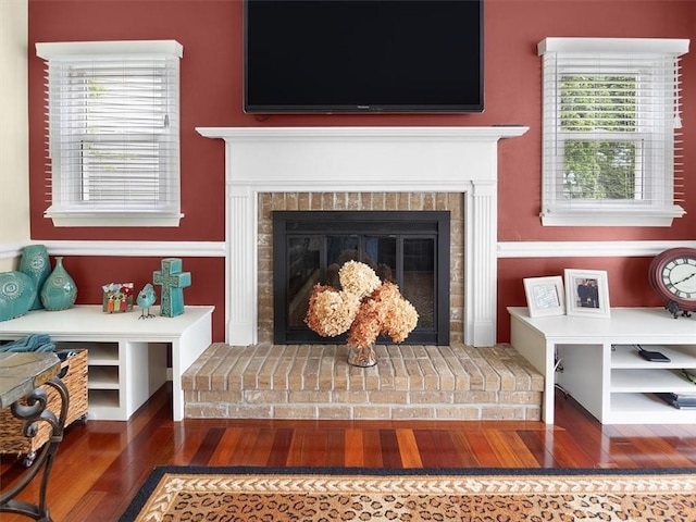 27 Black Spruce Ct, Greece, NY 14616 - detailed view of wood finished floors and a brick fireplace