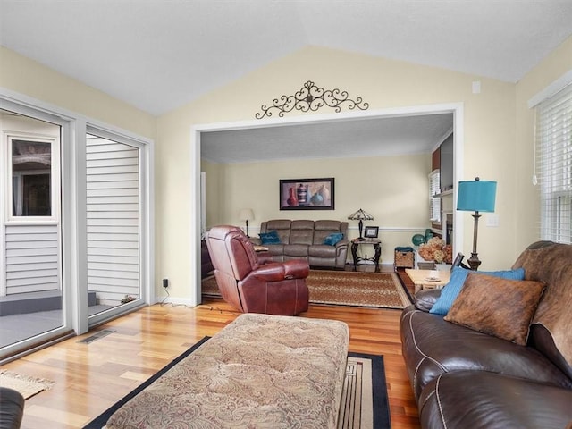 27 Black Spruce Ct, Greece, NY 14616 - living room featuring vaulted ceiling and wood finished floors