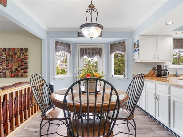 27 Black Spruce Ct, Greece, NY 14616 - dining area with light wood finished floors, recessed lighting, and crown molding