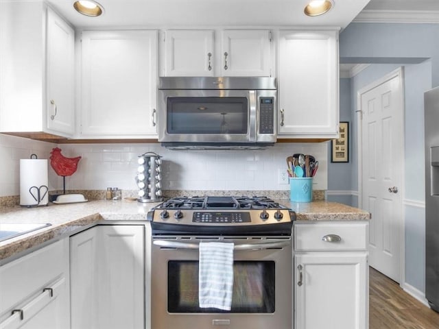 27 Black Spruce Ct, Greece, NY 14616 - kitchen featuring stainless steel appliances, white cabinetry, light countertops, crown molding, and tasteful backsplash