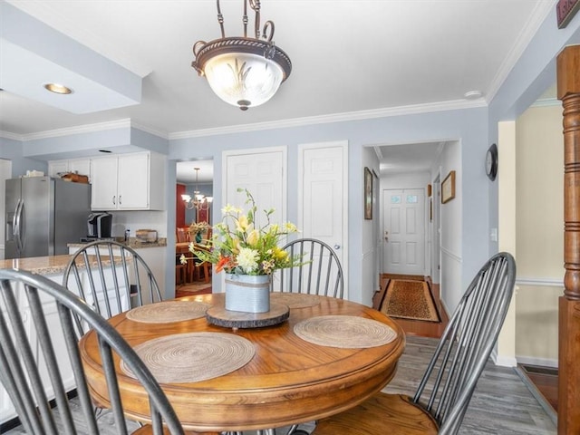 27 Black Spruce Ct, Greece, NY 14616 - dining room with a chandelier, wood finished floors, and crown molding