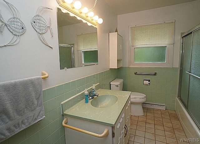 3840 Coomer Rd, Newfane, NY 14108 - bathroom with tile walls, tile patterned flooring, baseboard heating, vanity, and a wainscoted wall