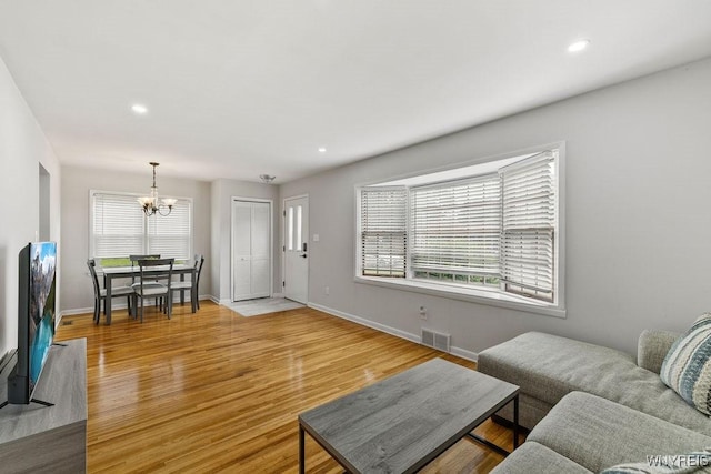 503 Kohl St, North Tonawanda, NY 14120 - living room featuring a chandelier, plenty of natural light, light wood finished floors, and recessed lighting