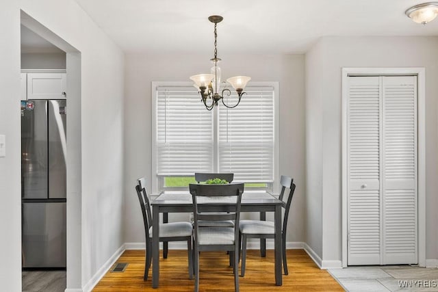 503 Kohl St, North Tonawanda, NY 14120 - dining space featuring a chandelier and light wood-style floors