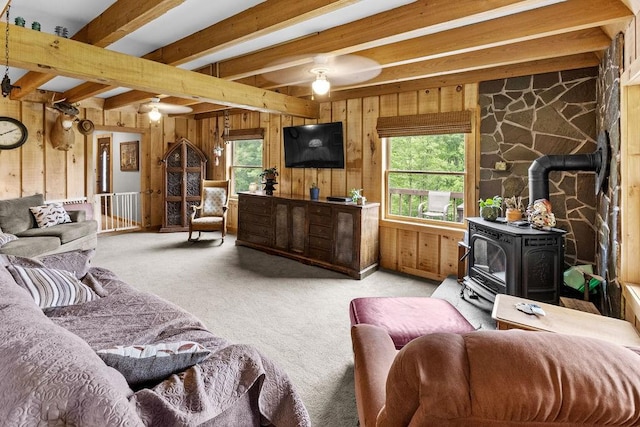 485 Spring Valley Rd, Delhi, NY 13753 - living room with a wood stove, ceiling fan, plenty of natural light, wooden walls, and carpet flooring