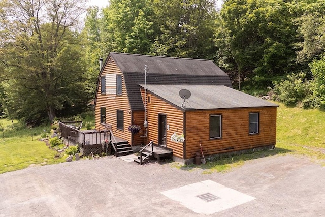 485 Spring Valley Rd, Delhi, NY 13753 - rustic home with a deck, a shingled roof, and a front yard