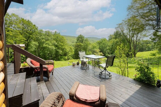485 Spring Valley Rd, Delhi, NY 13753 - deck featuring a view of trees, a lawn, and outdoor dining space