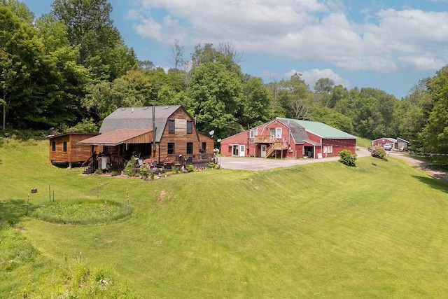 485 Spring Valley Rd, Delhi, NY 13753 - rear view of property with driveway, a gambrel roof, a lawn, a garage, and stairway