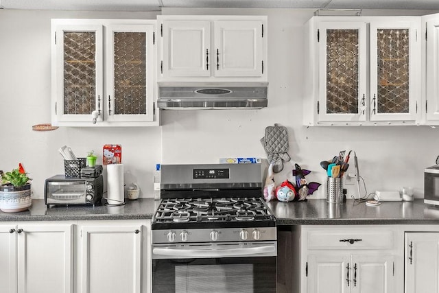 485 Spring Valley Rd, Delhi, NY 13753 - kitchen with stainless steel gas range, under cabinet range hood, white cabinetry, dark countertops, and glass insert cabinets