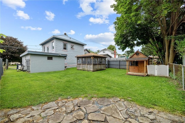 703 N Perry St, Dix, NY 14891 - rear view of property featuring a gazebo, a fenced backyard, and a storage unit