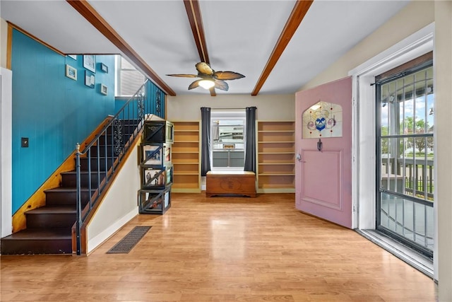 703 N Perry St, Dix, NY 14891 - entryway with beam ceiling, wood finished floors, a ceiling fan, and stairs