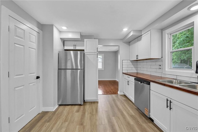 210 Sandra Ln, Clay, NY 13212 - kitchen with appliances with stainless steel finishes, light wood finished floors, white cabinets, and recessed lighting