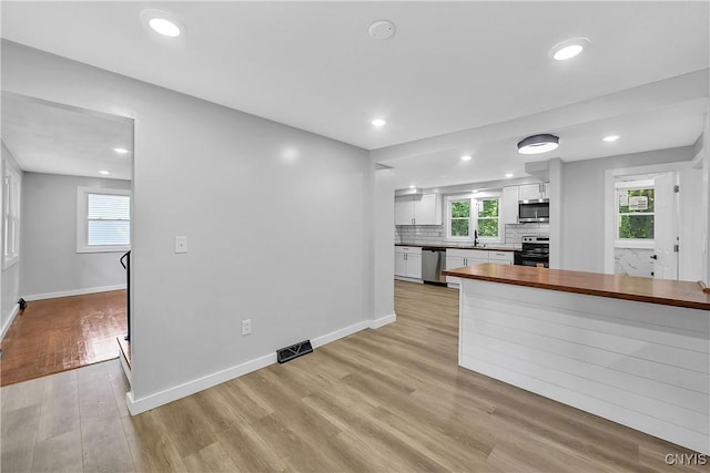 210 Sandra Ln, Clay, NY 13212 - kitchen featuring stainless steel appliances, wood counters, white cabinets, light wood-style flooring, and recessed lighting