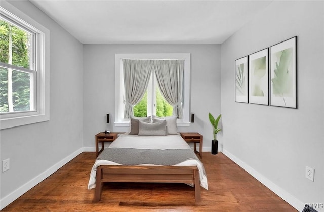 210 Sandra Ln, Clay, NY 13212 - bedroom with multiple windows and wood finished floors