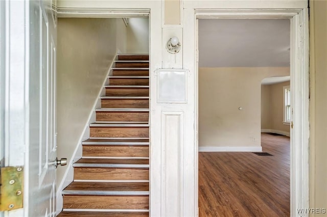 210 Carl St, Buffalo, NY 14215 - staircase featuring arched walkways and wood finished floors