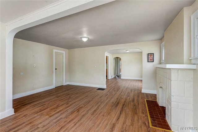 210 Carl St, Buffalo, NY 14215 - unfurnished living room featuring arched walkways and wood finished floors