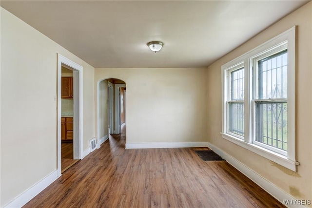 210 Carl St, Buffalo, NY 14215 - empty room featuring arched walkways and wood finished floors