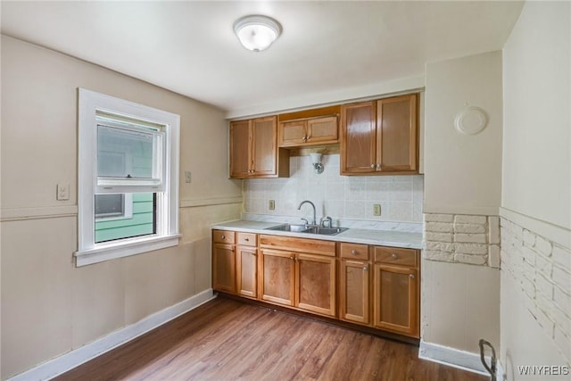 210 Carl St, Buffalo, NY 14215 - kitchen with wood finished floors, brown cabinets, light countertops, and tasteful backsplash