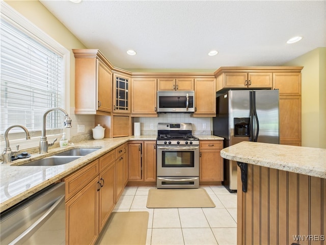 4166 Tisbury Ln, Hamburg, NY 14075 - kitchen with appliances with stainless steel finishes, light stone countertops, glass insert cabinets, tasteful backsplash, and recessed lighting