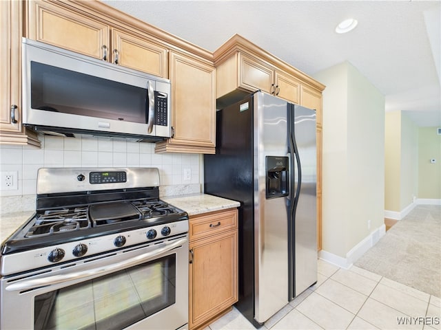 4166 Tisbury Ln, Hamburg, NY 14075 - kitchen with appliances with stainless steel finishes, backsplash, light stone counters, light tile patterned flooring, and light colored carpet