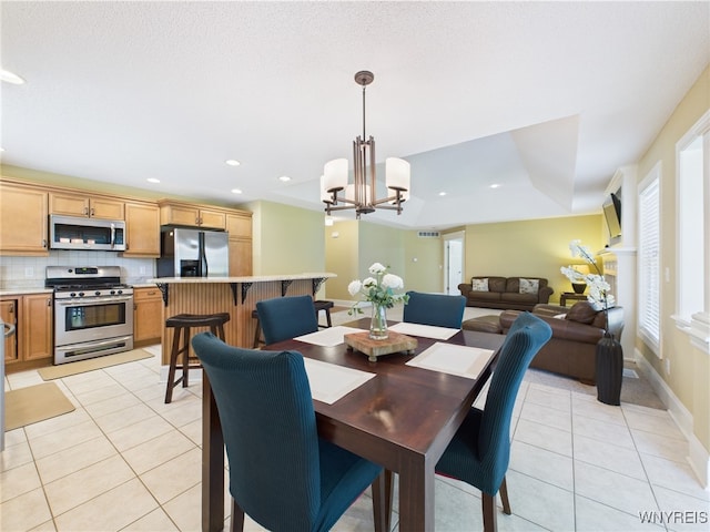 4166 Tisbury Ln, Hamburg, NY 14075 - dining space with light tile patterned floors, a chandelier, and recessed lighting