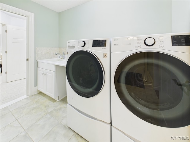 4166 Tisbury Ln, Hamburg, NY 14075 - washroom with washer and dryer, cabinet space, and light tile patterned flooring