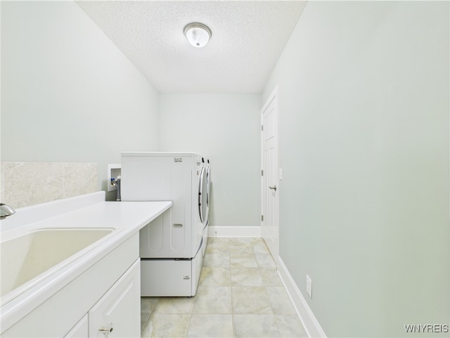 4166 Tisbury Ln, Hamburg, NY 14075 - laundry area with a textured ceiling, washer and clothes dryer, and light tile patterned flooring