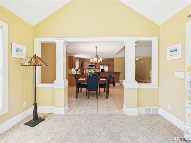 4166 Tisbury Ln, Hamburg, NY 14075 - dining room featuring decorative columns, vaulted ceiling, light carpet, and a chandelier