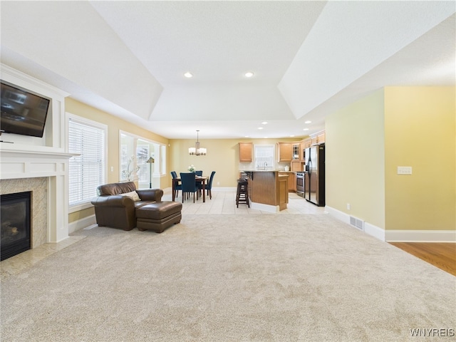 4166 Tisbury Ln, Hamburg, NY 14075 - living room featuring light colored carpet, a chandelier, a tray ceiling, and recessed lighting