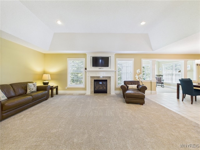 4166 Tisbury Ln, Hamburg, NY 14075 - carpeted living room featuring a tray ceiling, a fireplace with flush hearth, recessed lighting, and tile patterned flooring