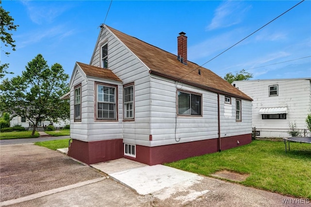357 Hastings Ave, Buffalo, NY 14215 - view of side of home featuring a chimney, a lawn, and a shingled roof