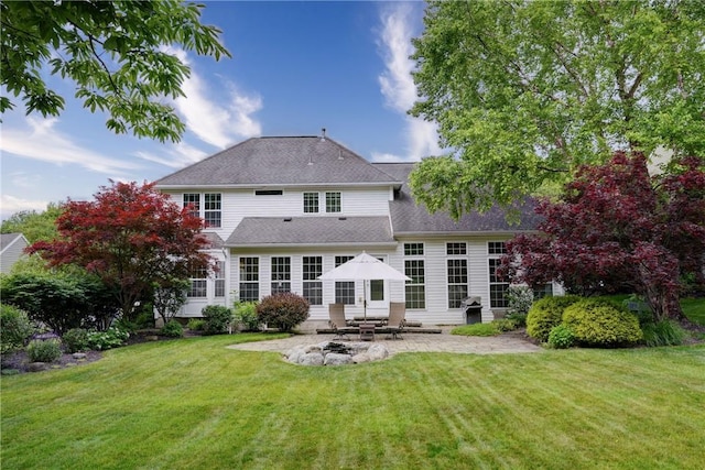 74 Chadwick Mnr, Perinton, NY 14450 - rear view of house with a patio area, a yard, and roof with shingles