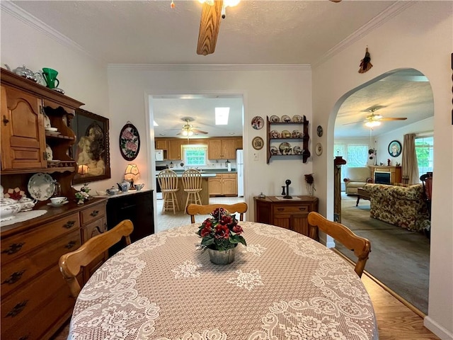12901 Washburn Rd, Butler, NY 14590 - dining space featuring a ceiling fan, arched walkways, and crown molding