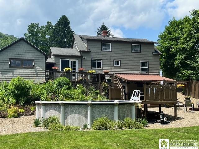 531 Fountain St, Olean-City, NY 14760 - rear view of property featuring a wooden deck, a lawn, and a chimney