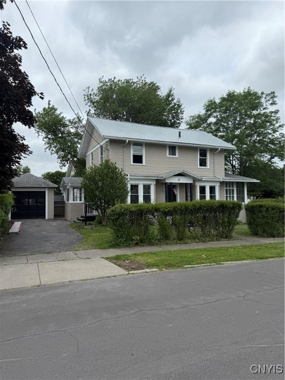 37 Peacock St, Auburn, NY 13021 - traditional home featuring an outbuilding and a metal roof