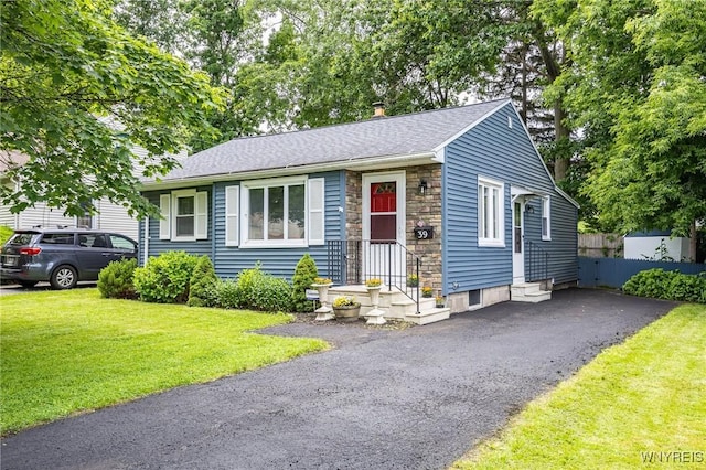 39 Marwood Rd, Greece, NY 14616 - view of front facade featuring stone siding, a front yard, and a shingled roof