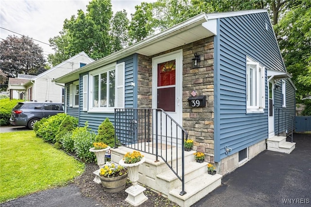39 Marwood Rd, Greece, NY 14616 - view of front of property with stone siding and a front yard