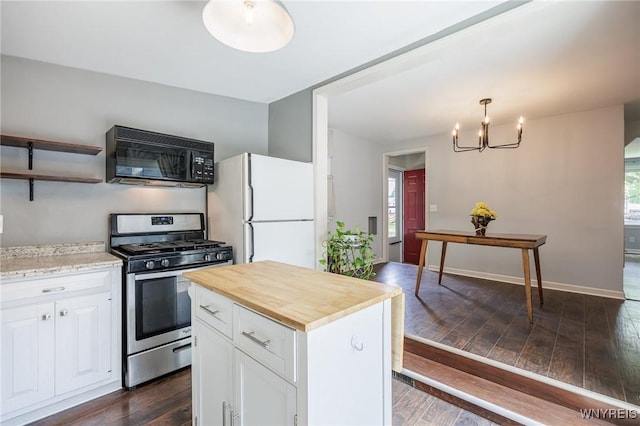 39 Marwood Rd, Greece, NY 14616 - kitchen with stainless steel gas range oven, black microwave, freestanding refrigerator, wooden counters, and a chandelier
