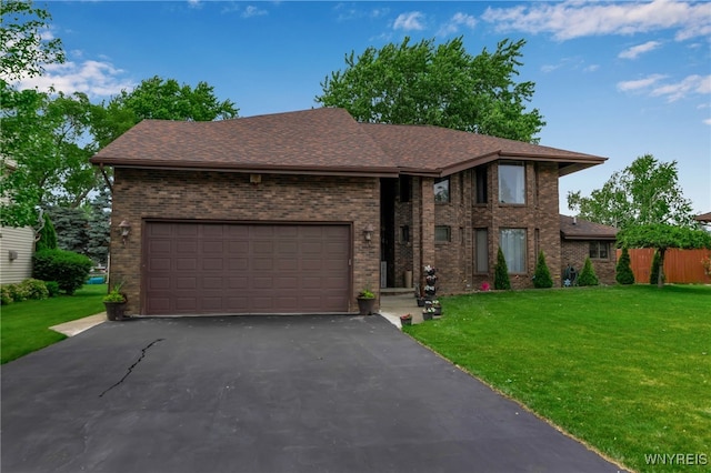 2160 Robert Dr, Niagara, NY 14304 - view of front of home with brick siding, a front lawn, asphalt driveway, roof with shingles, and a garage