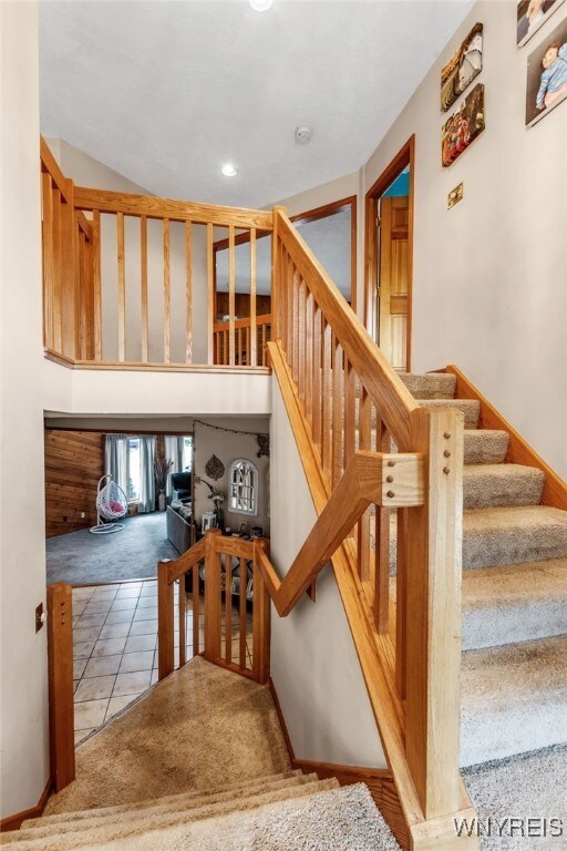 2160 Robert Dr, Niagara, NY 14304 - stairs with carpet and tile patterned flooring